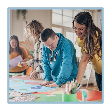 2 people supporting young people with their work.