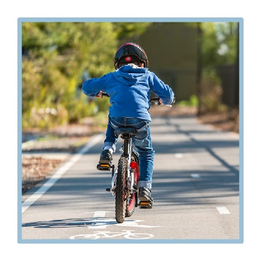 A child riding a bike. 