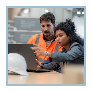 2 people working at a building site. 