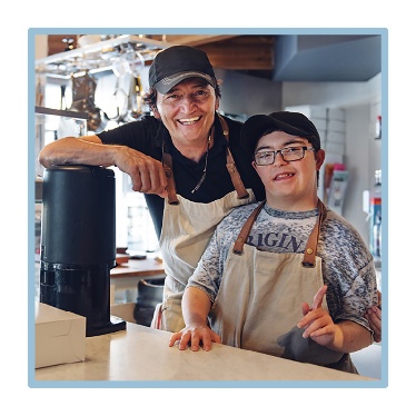2 people working at a cafe.