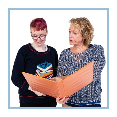 Someone supporting a person to read. 